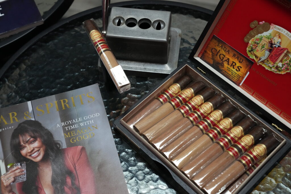 Premium cigars displayed at Saga Bay Cigars, featuring a variety of hand-rolled cigars and a cigar cutter.